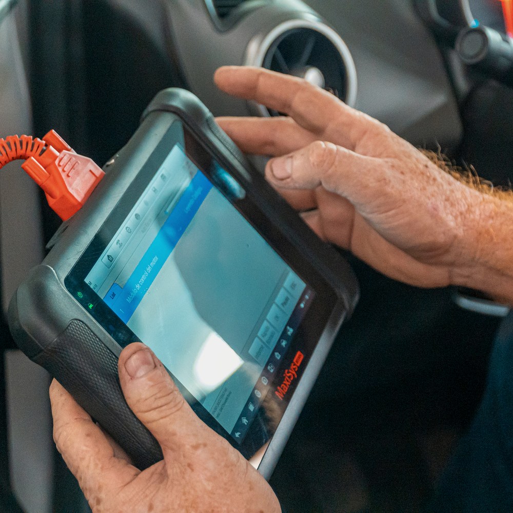New car key being programmed to the vehicle through the OBD port